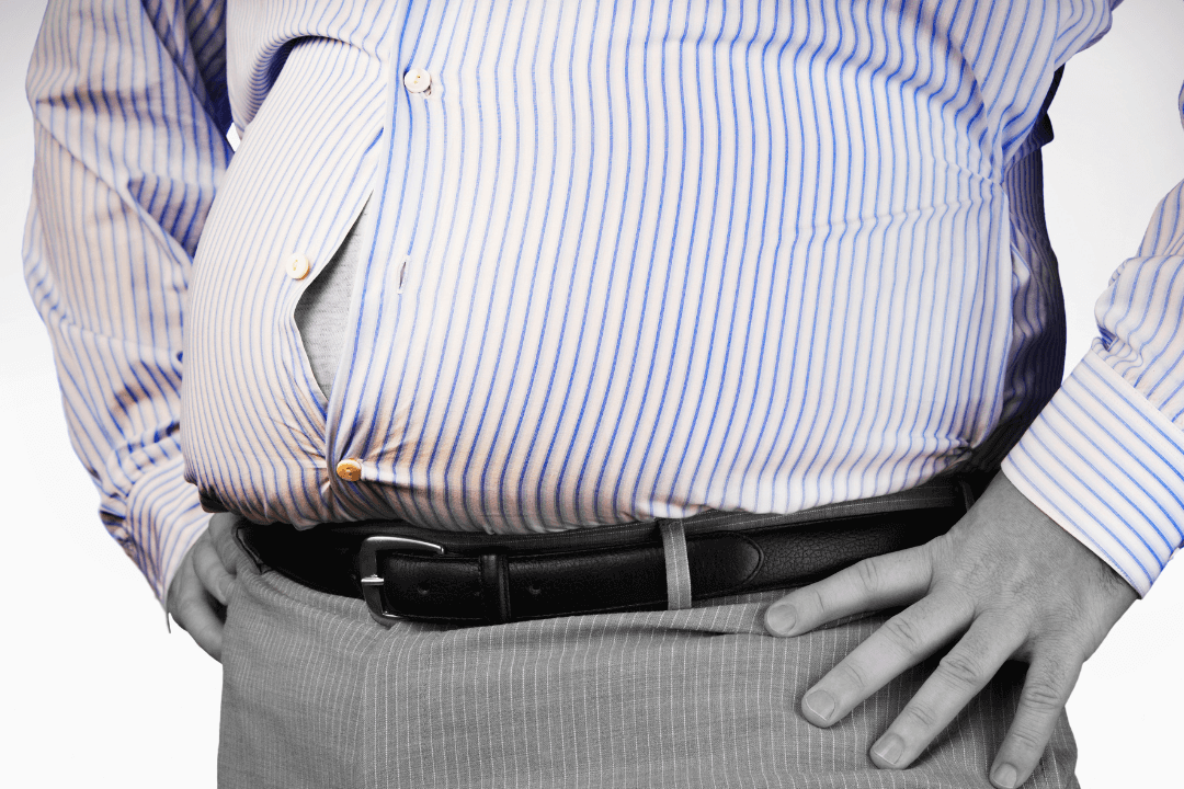 man with big stomach hanging over belt