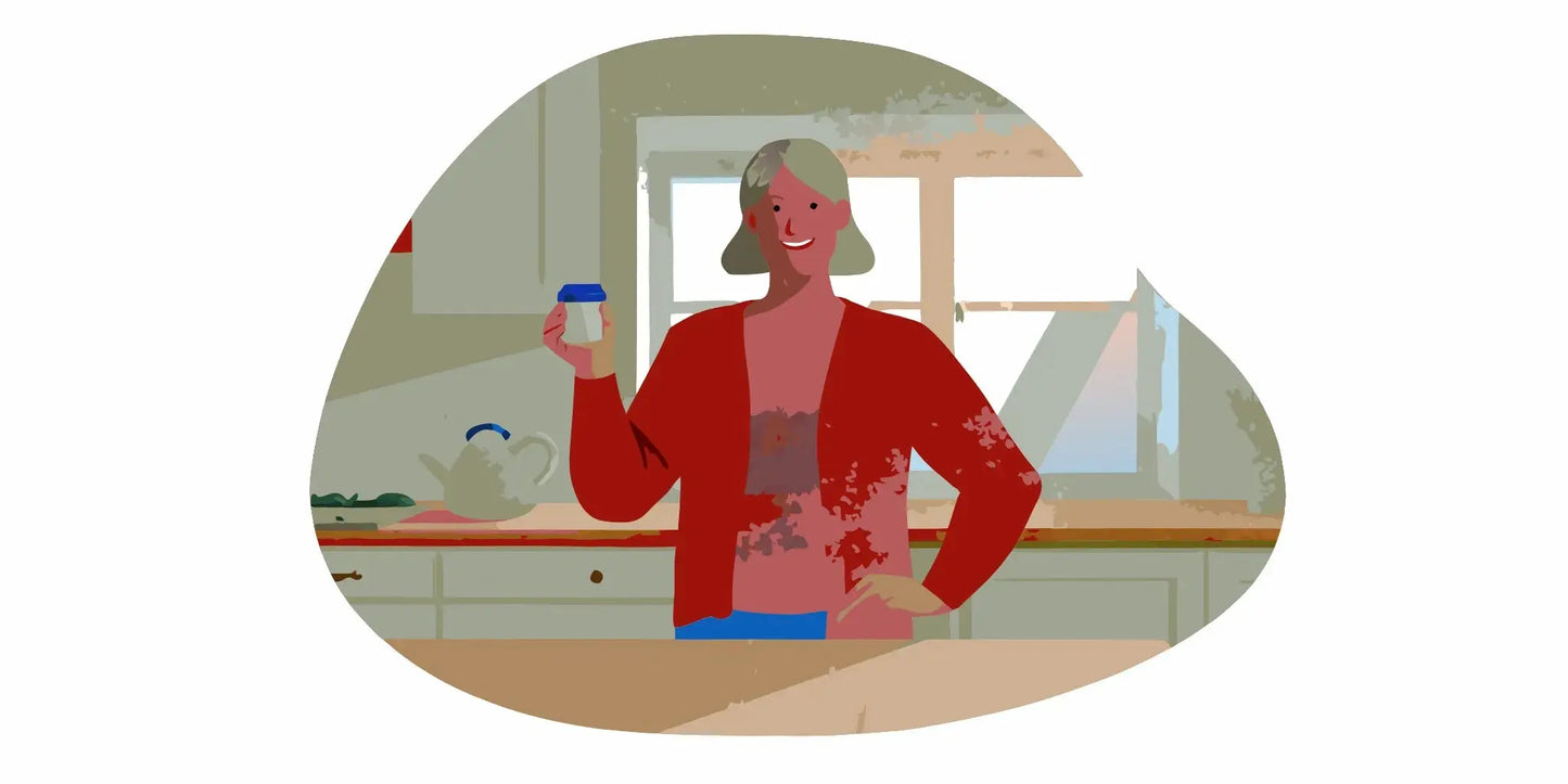 Older woman in her kitchen holding a supplement bottle, natural daylight