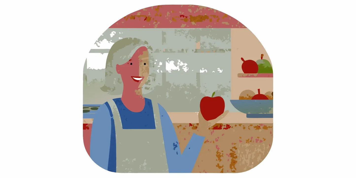 Woman over 60 smiling warmly in a sunlit kitchen holding a red apple, heart health theme