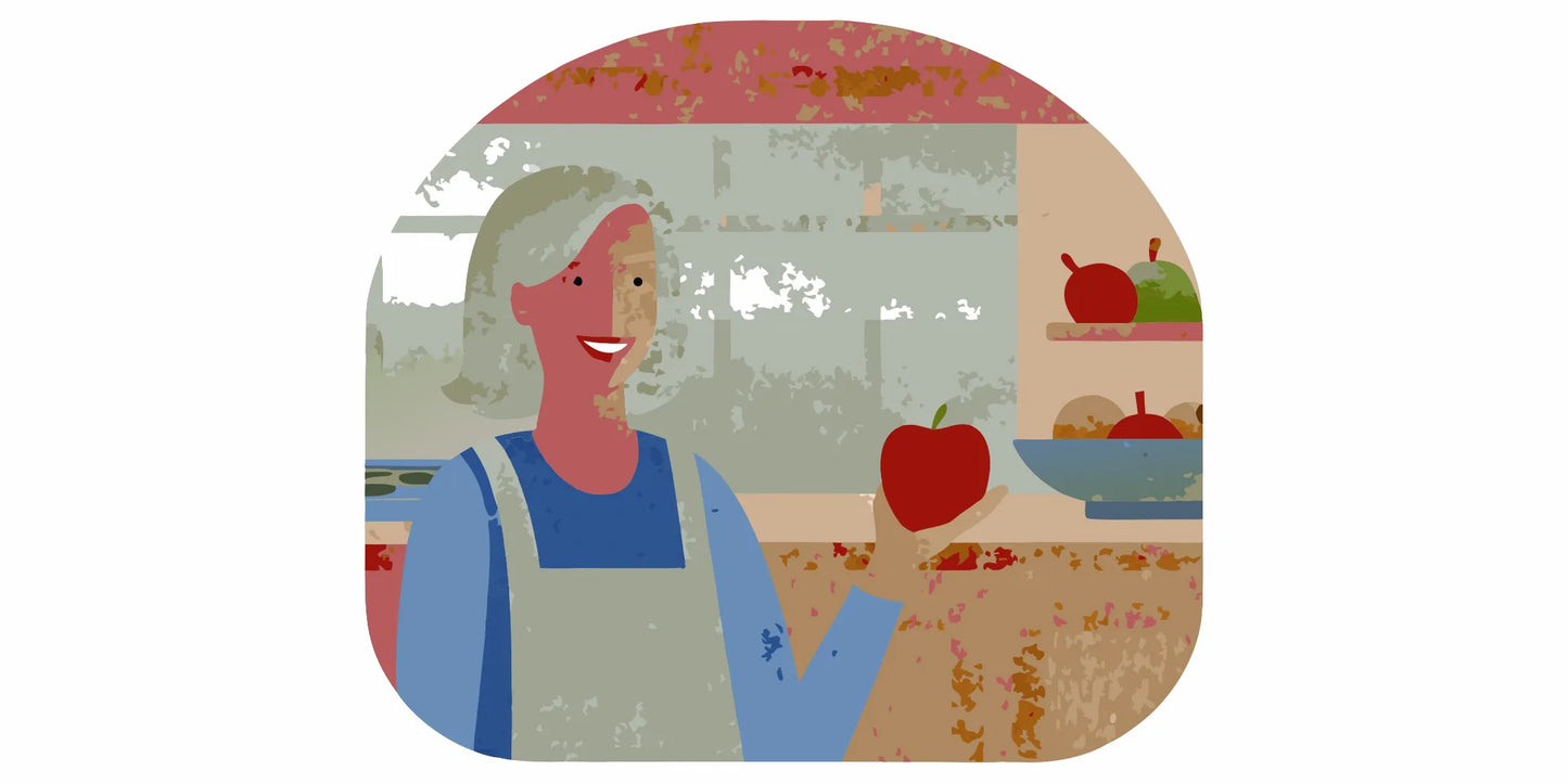 Woman over 60 smiling warmly in a sunlit kitchen holding a red apple, heart health theme